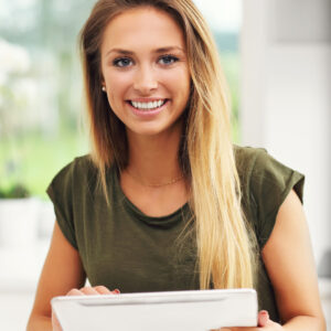 Picture of young woman with tablet in kitchen